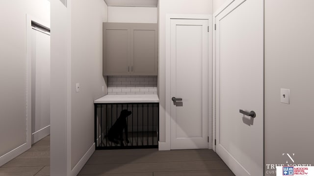 interior space with hardwood / wood-style floors and backsplash