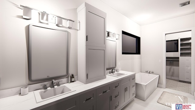 bathroom with a tub, tile patterned floors, and vanity