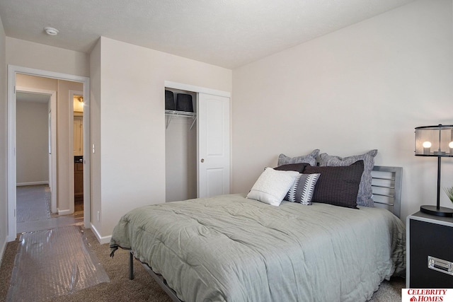 bedroom with a textured ceiling, a closet, and carpet floors