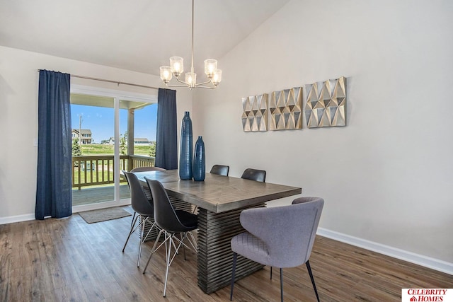 dining room with lofted ceiling, wood-type flooring, and a notable chandelier