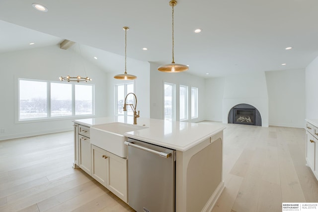 kitchen featuring recessed lighting, a large fireplace, a sink, light wood-style floors, and dishwasher