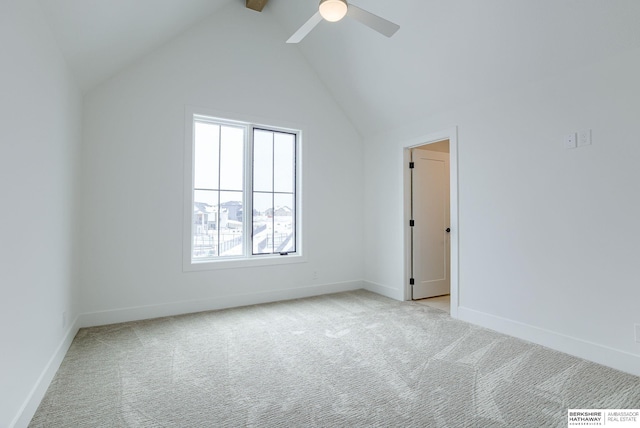 empty room featuring baseboards, vaulted ceiling with beams, ceiling fan, and light colored carpet