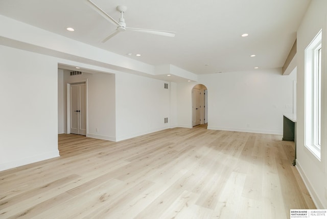 spare room with recessed lighting, arched walkways, ceiling fan, and light wood-style floors
