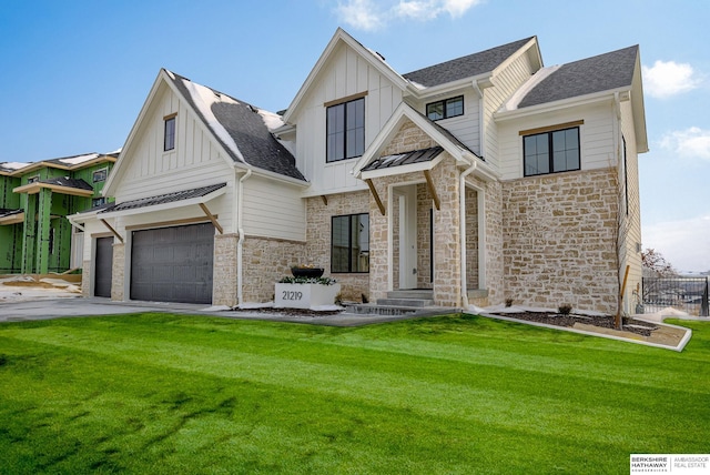 view of front facade featuring board and batten siding, a garage, stone siding, roof with shingles, and a front yard
