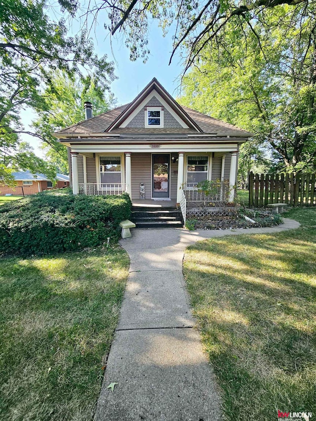 view of front of house featuring a front yard and covered porch