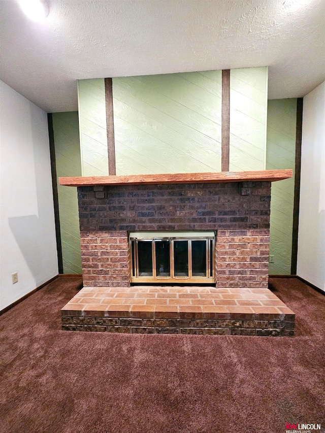 interior space featuring a textured ceiling, carpet flooring, and a brick fireplace