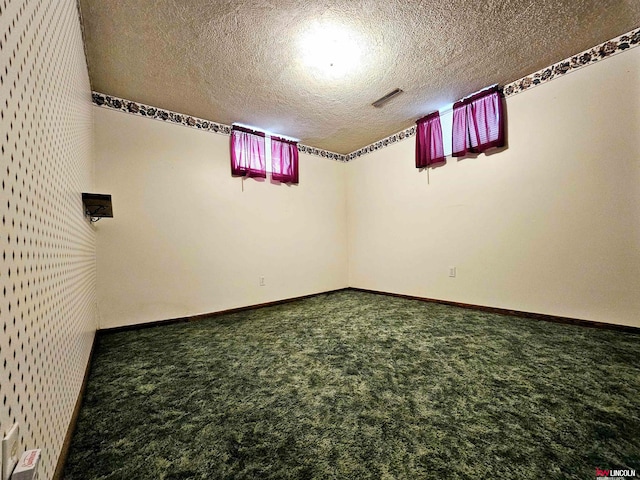 basement featuring a textured ceiling and carpet floors