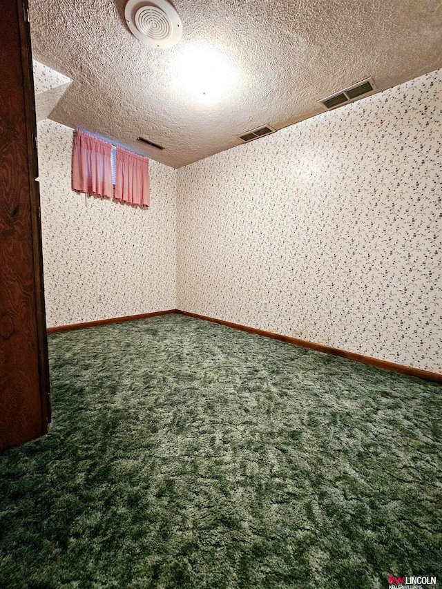 basement with carpet flooring and a textured ceiling