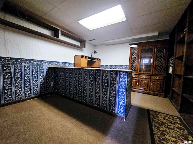 bar with a paneled ceiling and carpet flooring