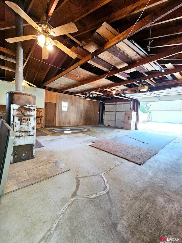 garage with wood walls and ceiling fan