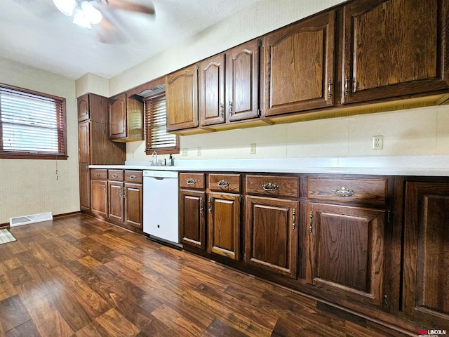 kitchen featuring white dishwasher, sink, dark hardwood / wood-style floors, ceiling fan, and dark brown cabinetry