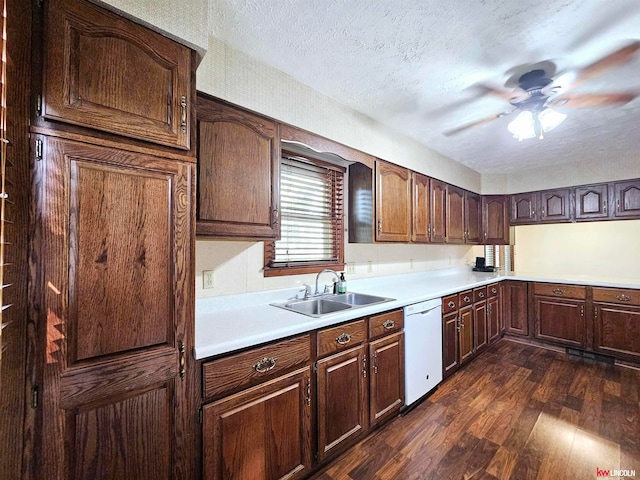 kitchen featuring dishwasher, sink, dark wood-type flooring, ceiling fan, and a textured ceiling