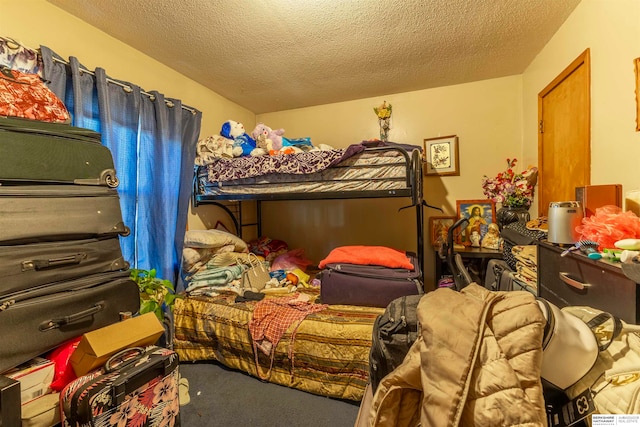 bedroom featuring a textured ceiling and carpet floors