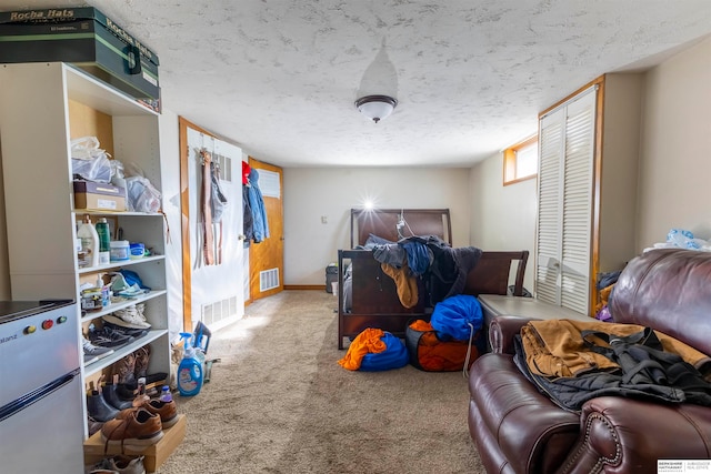 carpeted bedroom with a textured ceiling and a closet