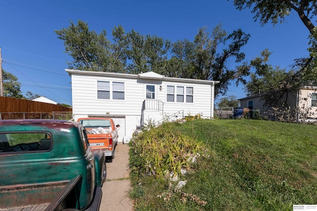 rear view of property featuring a yard