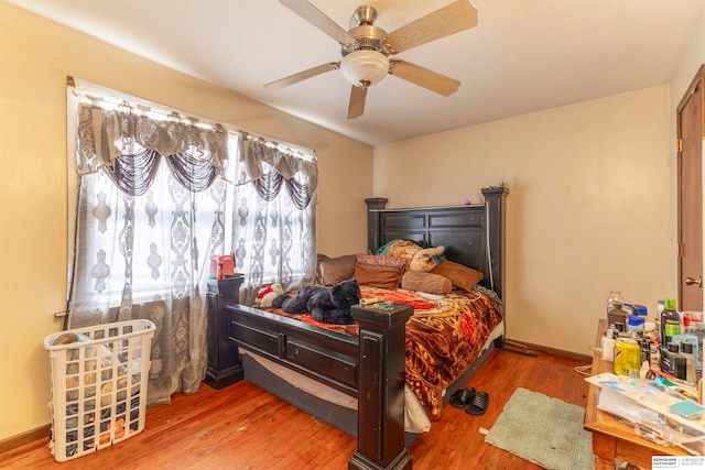 bedroom with ceiling fan and hardwood / wood-style flooring