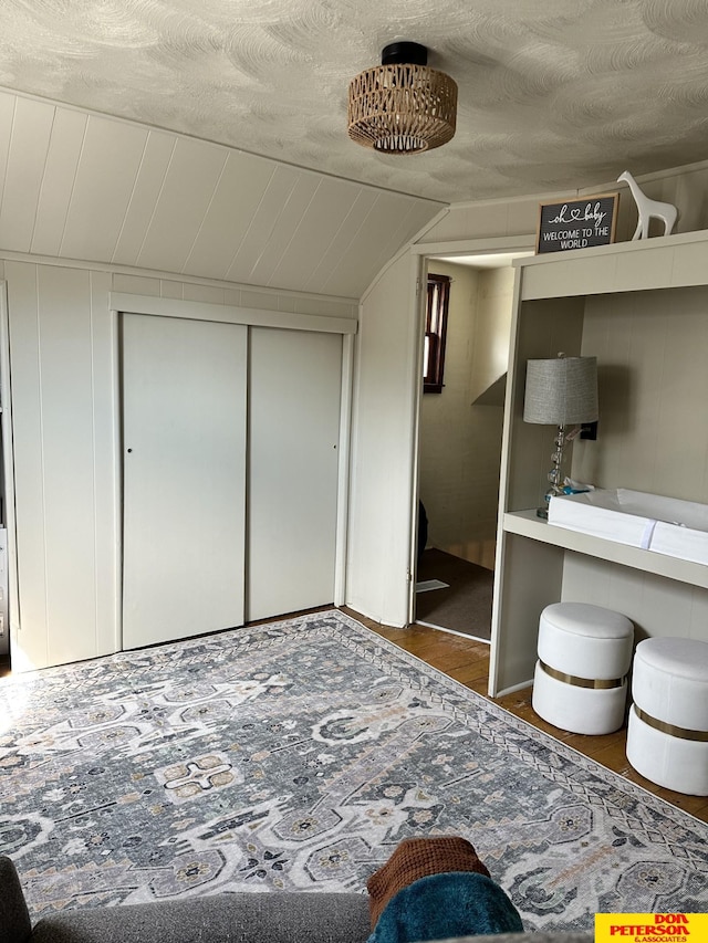 interior space featuring lofted ceiling and a textured ceiling