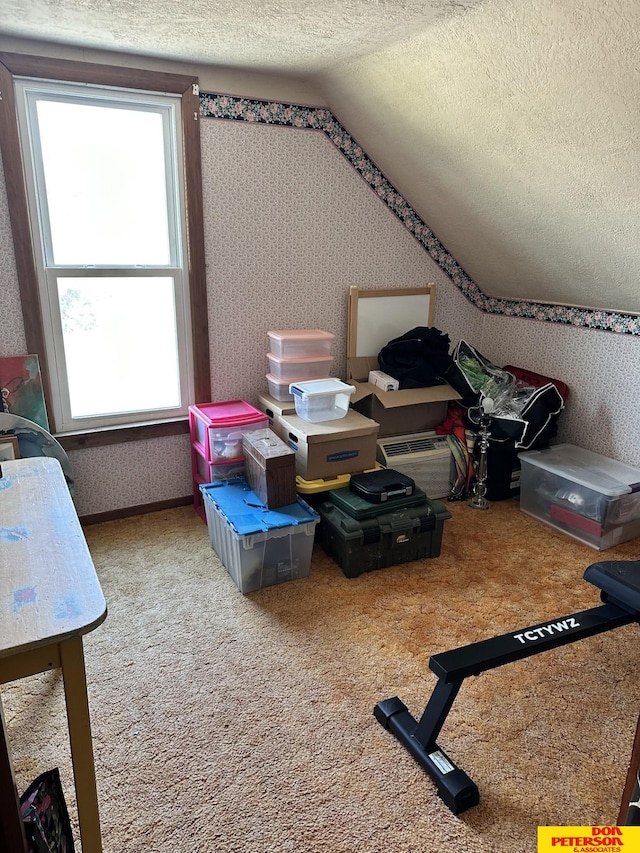 bonus room featuring lofted ceiling, a wealth of natural light, carpet, and a textured ceiling