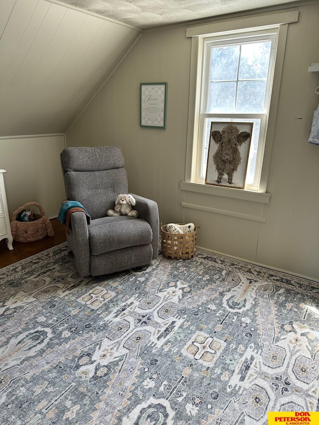 sitting room with lofted ceiling and hardwood / wood-style floors