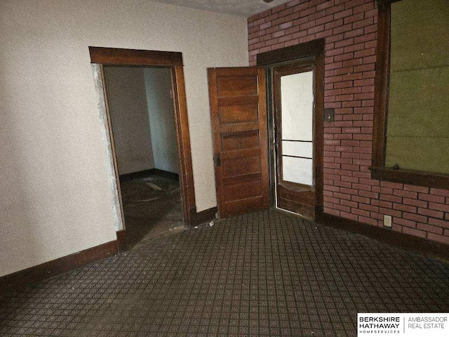 empty room with dark colored carpet