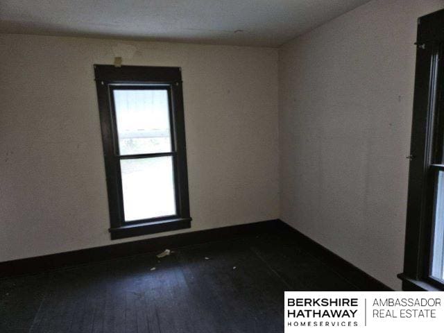 unfurnished room featuring dark wood-type flooring