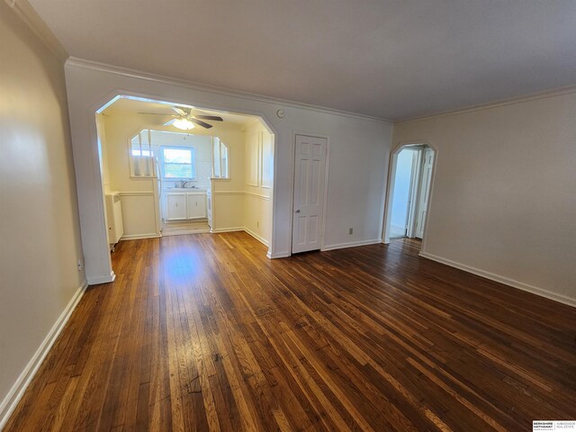 spare room with ornamental molding, dark hardwood / wood-style flooring, and ceiling fan