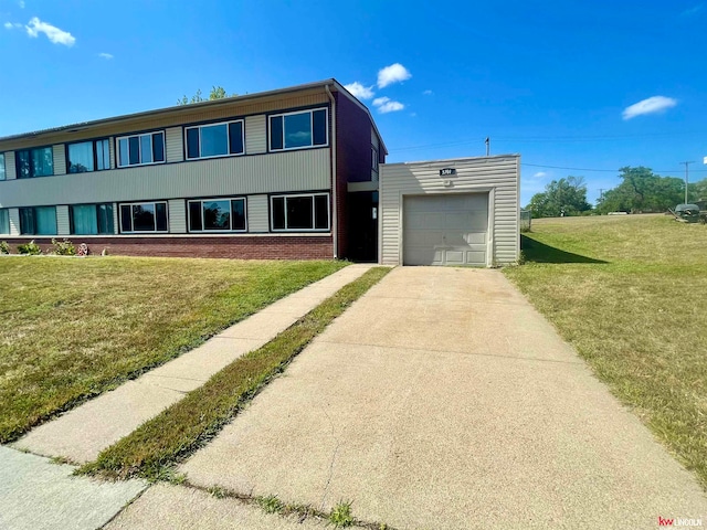 view of front facade with a garage and a front lawn