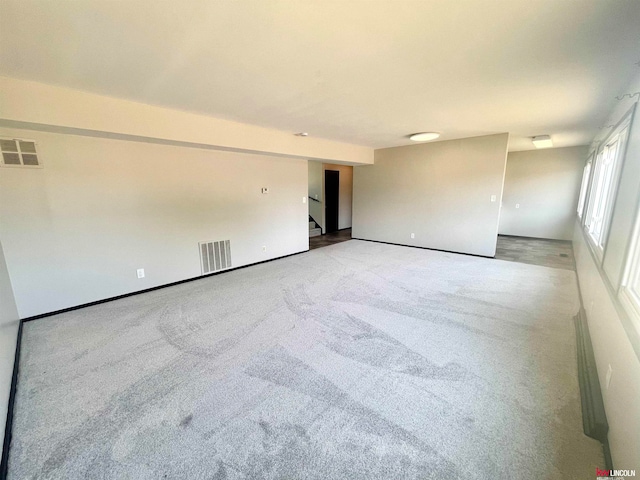 unfurnished room with light carpet