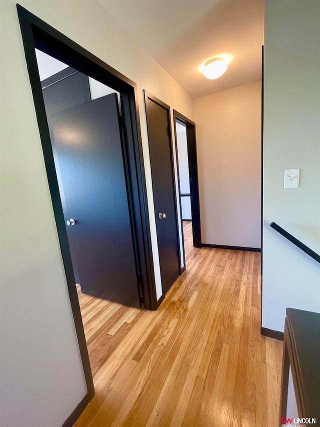 corridor with light hardwood / wood-style floors