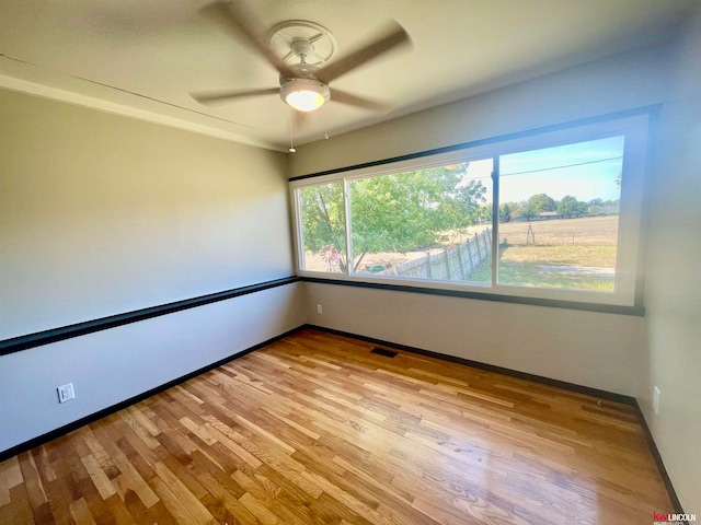 spare room with ceiling fan and light hardwood / wood-style flooring