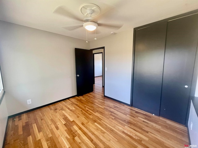 unfurnished bedroom with a closet, ceiling fan, and light hardwood / wood-style flooring