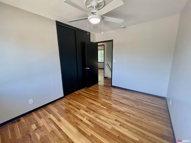 unfurnished bedroom featuring ceiling fan and light wood-type flooring