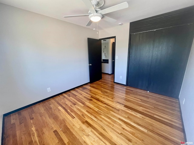 unfurnished bedroom featuring a closet, ceiling fan, and hardwood / wood-style flooring