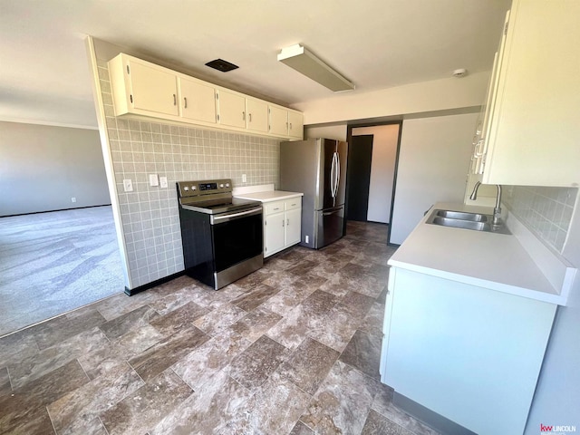 kitchen with backsplash, stainless steel appliances, white cabinetry, and sink