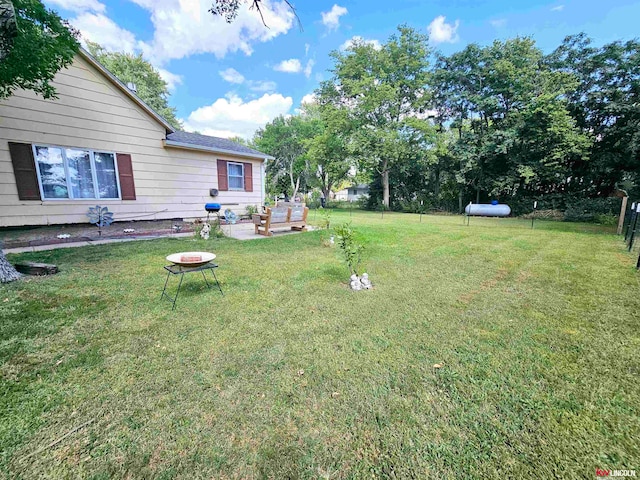 view of yard with an outdoor fire pit