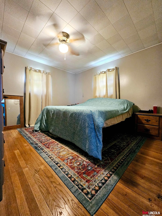 bedroom featuring ceiling fan and hardwood / wood-style flooring