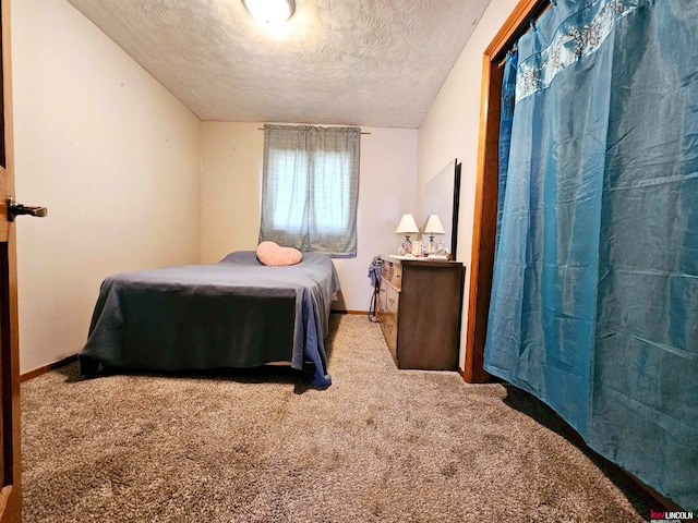 carpeted bedroom with a textured ceiling