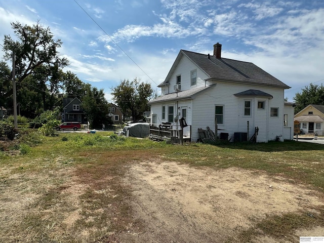 back of house featuring central air condition unit