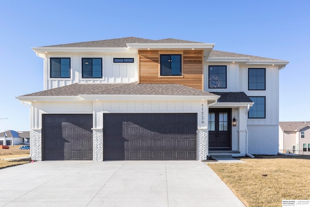 view of front of house with a garage and a front lawn