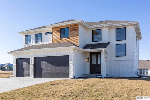 view of front facade with a garage and a front lawn