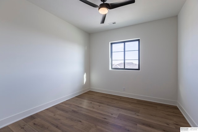 empty room featuring ceiling fan and dark wood-type flooring