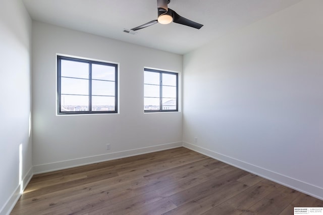 empty room featuring ceiling fan and hardwood / wood-style floors