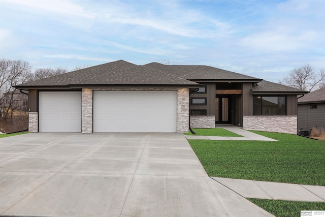 prairie-style house featuring a front yard and a garage