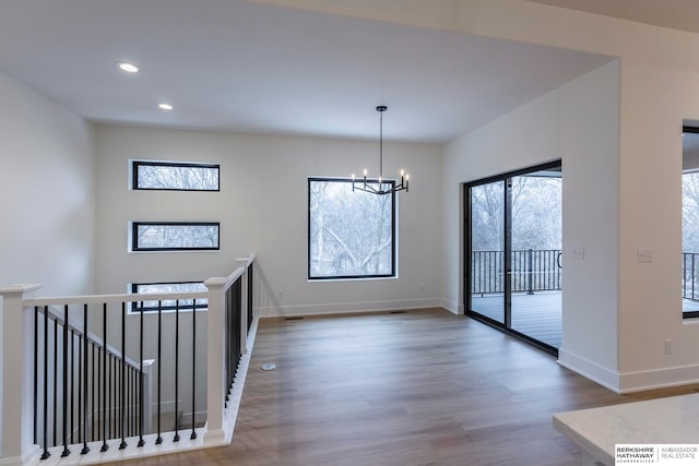 interior space featuring a notable chandelier and wood-type flooring