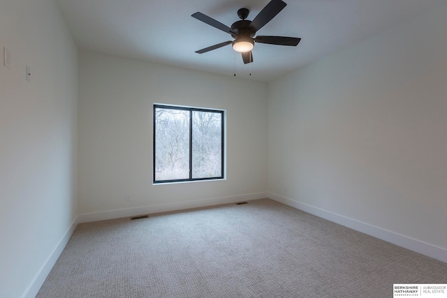 carpeted spare room with ceiling fan