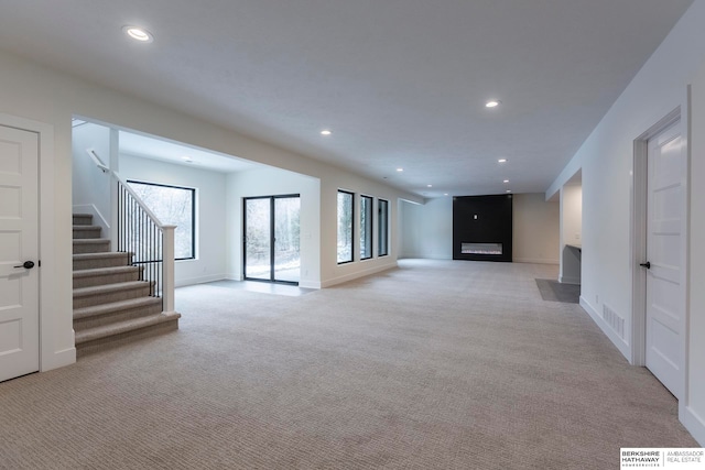 unfurnished living room with light colored carpet