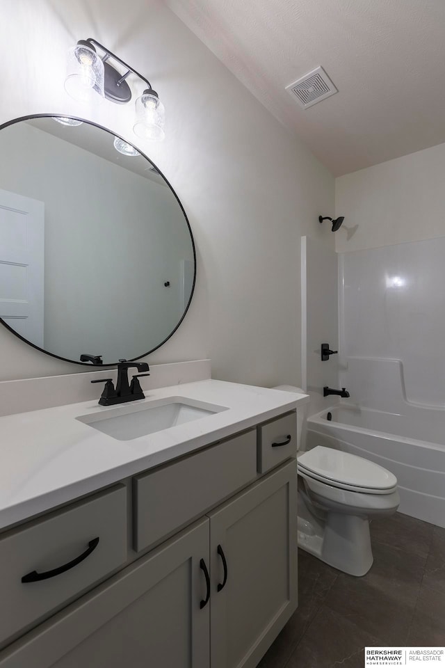 full bathroom featuring bathing tub / shower combination, tile patterned flooring, vanity, and toilet