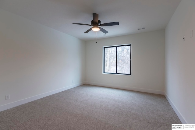 spare room with light carpet and ceiling fan