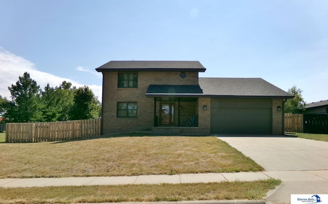 view of front of house with a garage and a front lawn