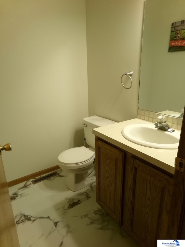 bathroom featuring vanity and toilet